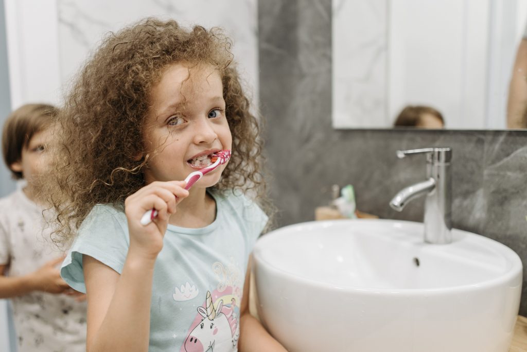 girl brushing her teeth